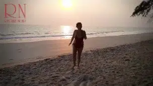 Nice lady at lonely nudist beach. Red swimsuit. Red bikini. Coconut