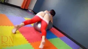 Regina Noir. A woman in yoga leotards practices yoga in the gym. Transparent red leotard yoga. 3